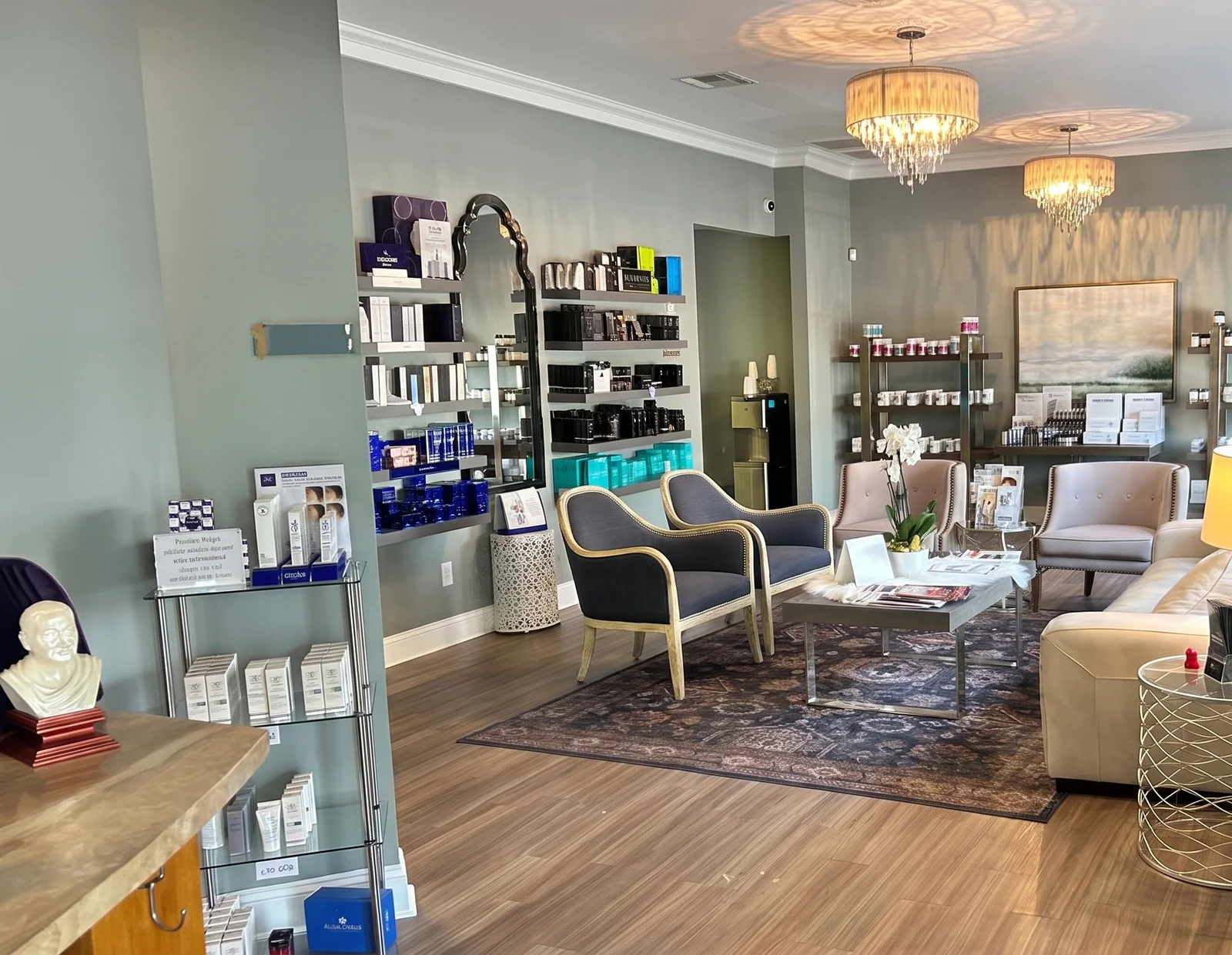RegenesisMD clinic interior with lounge seating, a coffee table, and skincare display shelves